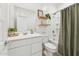 Clean bathroom featuring white fixtures, a shower-tub combo, floating shelves, and decorative accents at 12672 W Marguerite Ave, Avondale, AZ 85323