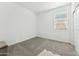 Bright bedroom features neutral tones, carpeted floors, and natural light from the large window at 12672 W Marguerite Ave, Avondale, AZ 85323