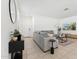 Comfortable living room featuring a gray sofa, tile flooring, and a flat-screen TV at 12672 W Marguerite Ave, Avondale, AZ 85323