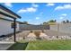 Beautiful backyard featuring rock landscaping, a green lawn, and a decorative rock border at 13224 N 31St Pl, Phoenix, AZ 85032