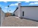Side view of a home with a graveled yard and a tall cinderblock fence for privacy at 13224 N 31St Pl, Phoenix, AZ 85032