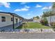 A delightful backyard featuring rock landscaping, a green lawn, and a covered patio at 13224 N 31St Pl, Phoenix, AZ 85032