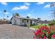 Well-maintained backyard featuring a covered patio, green lawn, mature landscaping, and privacy fencing at 13224 N 31St Pl, Phoenix, AZ 85032