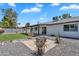 Well-kept backyard featuring a fire pit, rock landscaping, a green lawn, and a covered patio at 13224 N 31St Pl, Phoenix, AZ 85032