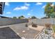 Large gravel backyard with a paved fire pit area, and desert landscaping near a block wall at 13224 N 31St Pl, Phoenix, AZ 85032