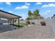 Spacious backyard with gravel and white rock landscaping, a lawn, and a covered patio at 13224 N 31St Pl, Phoenix, AZ 85032