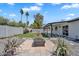 Landscaped backyard with a stone patio, firepit, lush green lawn, and privacy fence at 13224 N 31St Pl, Phoenix, AZ 85032