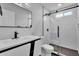 Modern bathroom with sleek vanity, matte black fixtures, and a glass-enclosed shower with unique tile at 13224 N 31St Pl, Phoenix, AZ 85032