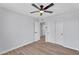Bedroom features neutral walls, wood-look floors, a ceiling fan, and closet with sliding doors at 13224 N 31St Pl, Phoenix, AZ 85032