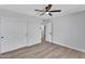 Bedroom featuring neutral walls, wood-look floors, a ceiling fan, and a closet with sliding doors at 13224 N 31St Pl, Phoenix, AZ 85032