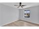 Bright bedroom featuring neutral walls, wood-look floors, ceiling fan, and a window overlooking the exterior at 13224 N 31St Pl, Phoenix, AZ 85032