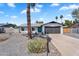 Attractive single-story home with a well-kept front yard, a gray brick facade, and an attached two-car garage at 13224 N 31St Pl, Phoenix, AZ 85032