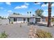 Charming single-story home with a well-manicured, low maintenance front yard, and a dark gray garage door at 13224 N 31St Pl, Phoenix, AZ 85032