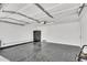 Spacious garage with epoxy flooring, white walls, overhead storage, and ample room for parking and storage at 13224 N 31St Pl, Phoenix, AZ 85032