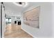 Bright hallway featuring modern lighting, neutral walls, and views into the kitchen and dining area at 13224 N 31St Pl, Phoenix, AZ 85032