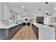Spacious kitchen featuring stylish two-tone cabinetry, sleek countertops, stainless steel appliances, and hardwood flooring at 13224 N 31St Pl, Phoenix, AZ 85032