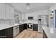 Modern kitchen with black and white cabinetry, stainless steel appliances, and a bright window at 13224 N 31St Pl, Phoenix, AZ 85032