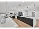 Open concept kitchen with a modern island, stainless steel appliances, and light-colored wood floors at 13224 N 31St Pl, Phoenix, AZ 85032