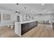 Open concept kitchen with a large island, bar seating, and modern pendant lighting at 13224 N 31St Pl, Phoenix, AZ 85032