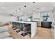 Beautiful open kitchen boasts an expansive island with waterfall edge and stainless steel appliances at 13224 N 31St Pl, Phoenix, AZ 85032