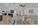 Open-concept living area featuring modern furnishings, hardwood floors, and an adjacent kitchen with a large island at 13224 N 31St Pl, Phoenix, AZ 85032