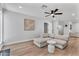 Open concept living room featuring a sectional sofa, light wood floors, and ample natural light at 13224 N 31St Pl, Phoenix, AZ 85032