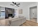 Bright living room featuring a modern fireplace, light-colored wood floors, and comfortable seating at 13224 N 31St Pl, Phoenix, AZ 85032