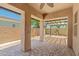 Covered patio with brick pavers and a view into the backyard at 14333 W Alvarado Dr, Goodyear, AZ 85395
