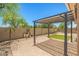 Backyard featuring a brick paver patio and a pergola with hanging lights at 14333 W Alvarado Dr, Goodyear, AZ 85395