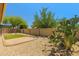 Serene backyard featuring desert landscaping, a pergola, and an artificial grass area at 14333 W Alvarado Dr, Goodyear, AZ 85395