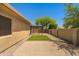 Charming backyard with desert landscape, pergola, and artificial grass area, offering relaxation at 14333 W Alvarado Dr, Goodyear, AZ 85395