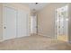 Neutral bedroom featuring carpet, dual closets, and a view into the adjacent bathroom at 14333 W Alvarado Dr, Goodyear, AZ 85395
