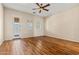 Bright, airy bedroom featuring hardwood floors, ceiling fan, and private door for a serene retreat at 14333 W Alvarado Dr, Goodyear, AZ 85395
