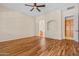 Spacious bedroom with hardwood floors, ceiling fan, and en-suite bathroom access at 14333 W Alvarado Dr, Goodyear, AZ 85395