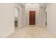 A bright foyer featuring tile flooring, high ceilings, and a dark wooden front door at 14333 W Alvarado Dr, Goodyear, AZ 85395
