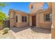 Charming front entrance featuring a turret-style design, a decorative door, and a brick-paved patio at 14333 W Alvarado Dr, Goodyear, AZ 85395