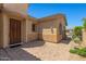 A beautiful front entrance with a decorative door, brick-paved patio, and manicured landscaping at 14333 W Alvarado Dr, Goodyear, AZ 85395