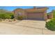 A front exterior with a concrete driveway, desert landscaping, and a home with a two-car garage at 14333 W Alvarado Dr, Goodyear, AZ 85395