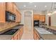 Well-equipped kitchen with granite counters, tiled backsplash, and black appliances providing style and functionality at 14333 W Alvarado Dr, Goodyear, AZ 85395