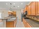 Spacious kitchen with wood cabinets, granite countertops, and modern appliances is perfect for culinary enthusiasts at 14333 W Alvarado Dr, Goodyear, AZ 85395