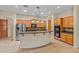 Gourmet kitchen island with granite countertop and stainless steel appliances, complemented by wood cabinetry at 14333 W Alvarado Dr, Goodyear, AZ 85395