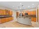 Gourmet kitchen island with granite countertop and stainless steel appliances, complemented by wood cabinetry at 14333 W Alvarado Dr, Goodyear, AZ 85395