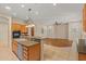 Open kitchen featuring granite countertops, stainless steel appliances, and seamless flow into the adjacent living area at 14333 W Alvarado Dr, Goodyear, AZ 85395