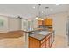 Kitchen with granite island, stainless steel appliances and light cabinets, seamlessly connecting the dining area at 14333 W Alvarado Dr, Goodyear, AZ 85395