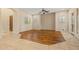 Bright living room features wood-look tile flooring, neutral paint, and abundant light from large windows at 14333 W Alvarado Dr, Goodyear, AZ 85395