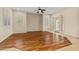 Spacious living room features wood-look tile flooring, plantation shutters, and neutral paint at 14333 W Alvarado Dr, Goodyear, AZ 85395