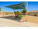 Community playground with shade canopy, swings, and slides offering a fun, safe outdoor space at 14333 W Alvarado Dr, Goodyear, AZ 85395