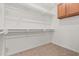 Spacious walk-in closet with carpet flooring, white walls, and shelving at 14333 W Alvarado Dr, Goodyear, AZ 85395