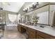 Well-lit bathroom showcasing a vanity with double sinks, a soaking tub, and decorative lighting at 1449 W Sherri Dr, Gilbert, AZ 85233