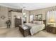 Spacious primary bedroom with wood floors, tray ceilings, and decorative accents throughout at 1449 W Sherri Dr, Gilbert, AZ 85233